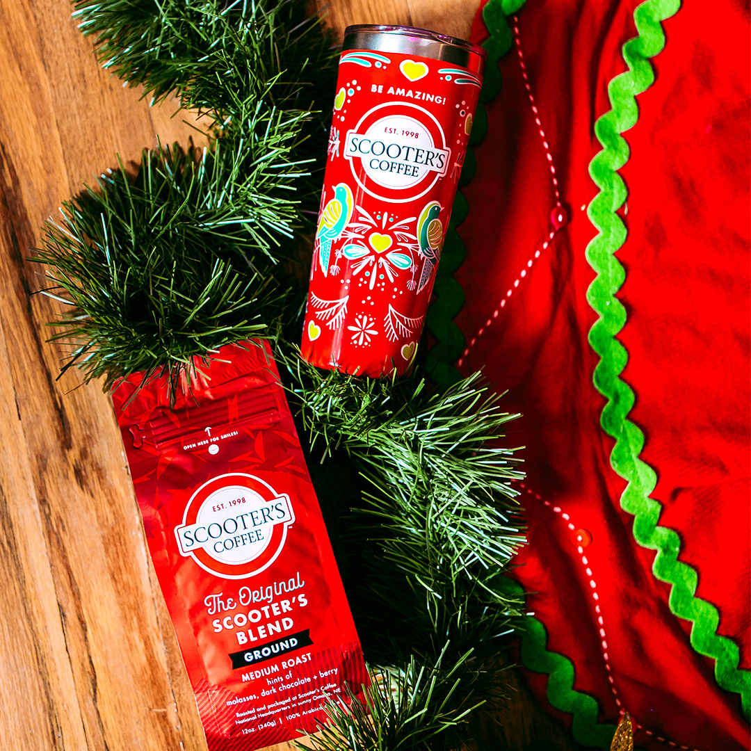 Bagged coffee next to red tumbler on table